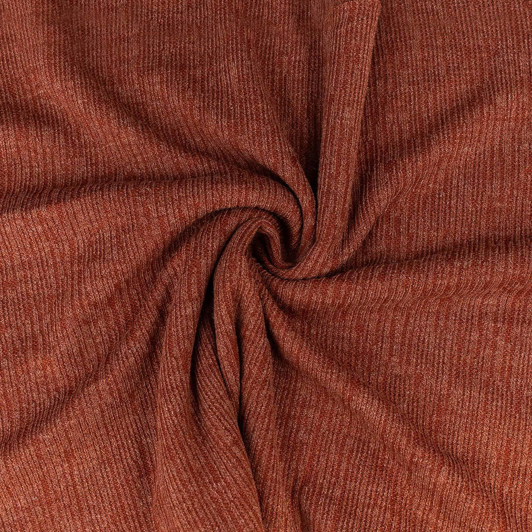 Close-up of brown ribbed fabric with a swirl pattern