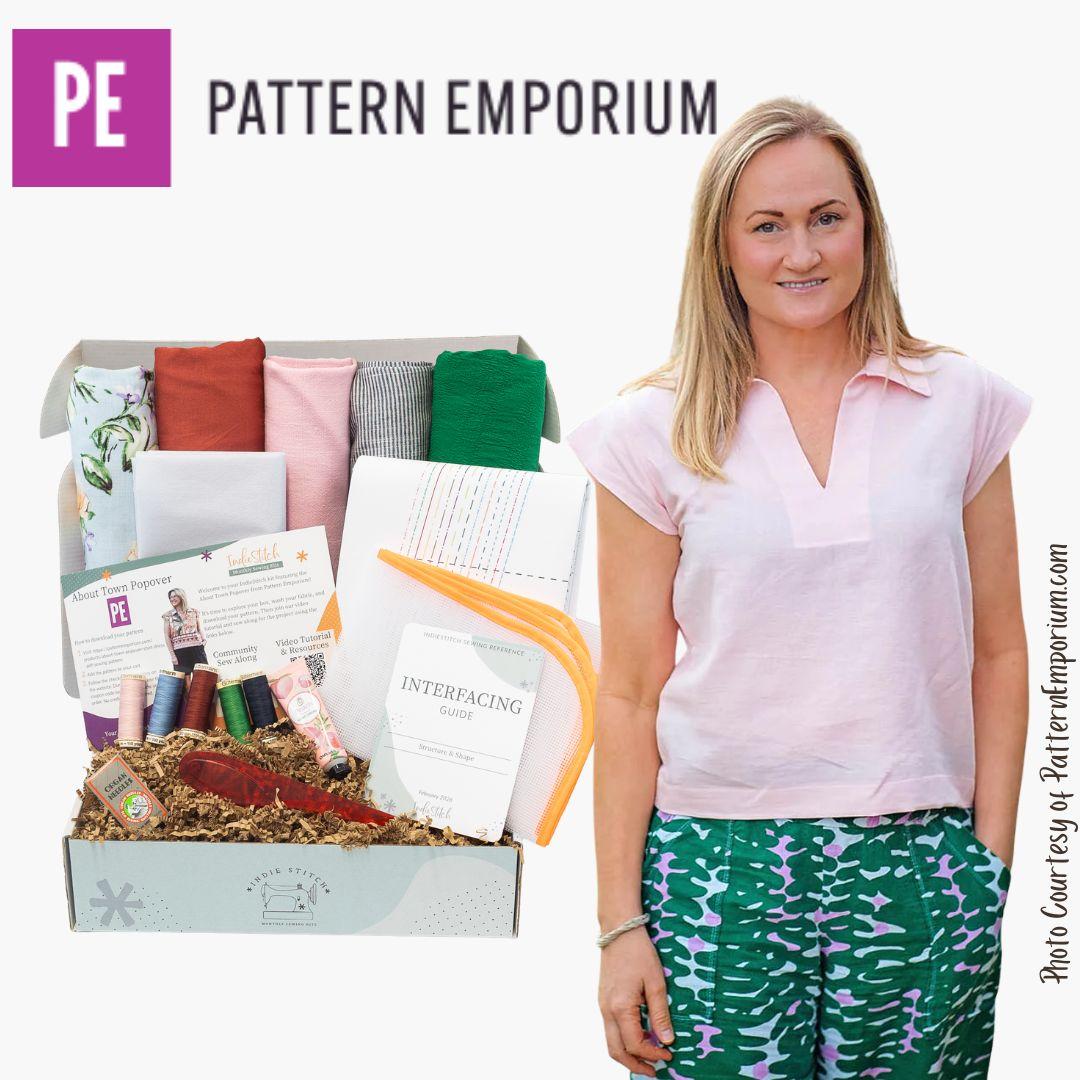 Woman standing next to a box from Pattern Emporium with fabric and sewing supplies.