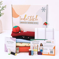 IndieStitch monthly sewing kit with materials and accessories on a white background