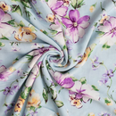 Floral fabric with purple and yellow flowers on a light blue background