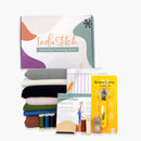 IndieStitch monthly sewing kit with fabric, threads, and tools on a white background