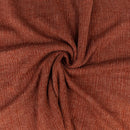 Close-up of brown ribbed fabric with a swirl pattern