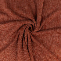 Close-up of brown ribbed fabric with a swirl pattern