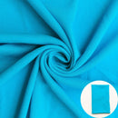 A turquoise blue fabric shown draped with a small circular inset of folded fabric.