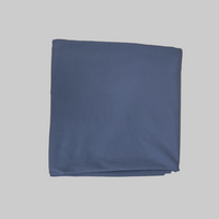 Folded blue fabric on a light gray background