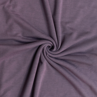 Close-up of purple french terry fabric with a swirl pattern