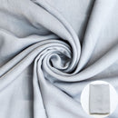 Gray fabric shown draped with a small circular inset of folded fabric.