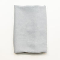 A folded piece of gray viscose fabric displayed flat against a clean white background.