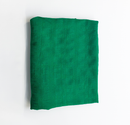 Folded green fabric on a white background