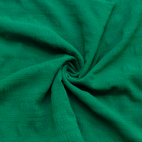 Close-up of check textured kelly green fabric with a swirl pattern