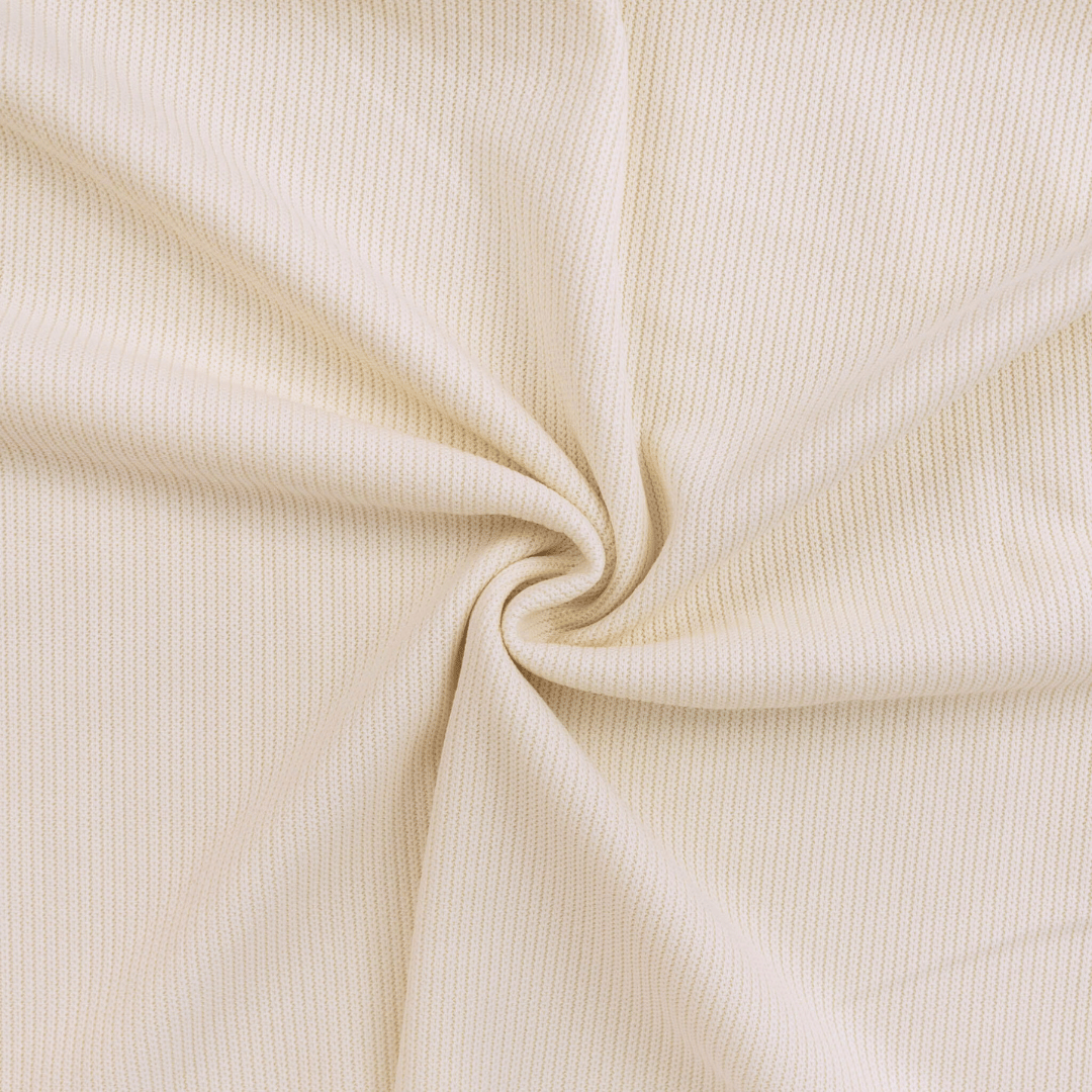 Close-up of beige ribbed fabric with a swirl pattern