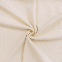 Close-up of beige ribbed fabric with a swirl pattern