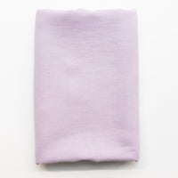 A folded piece of light lavender purple fabric displayed flat against a clean white background.