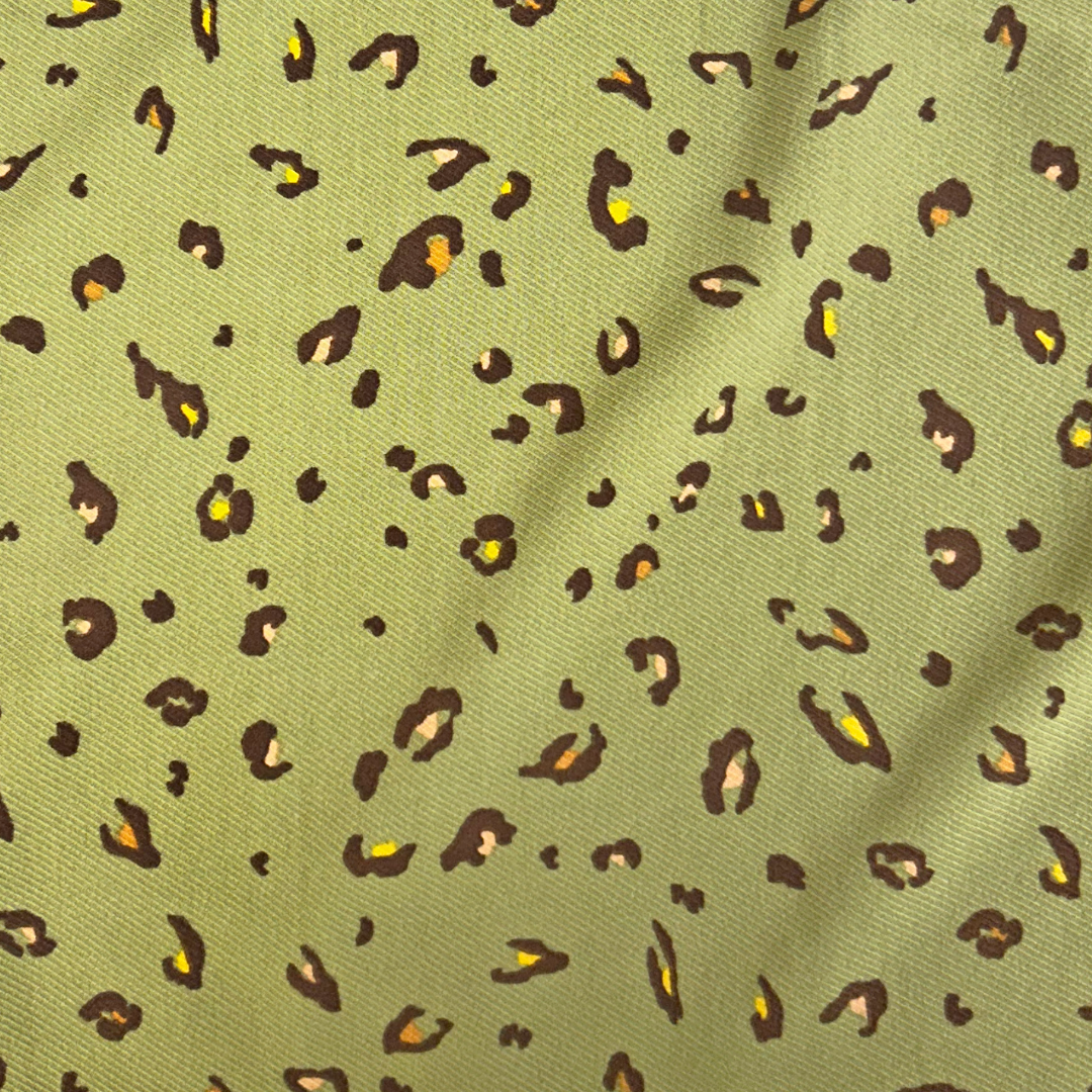 Green fabric with small leopard print pattern