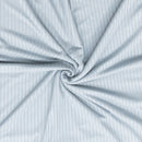 Close-up of light blue fabric with subtle pattern