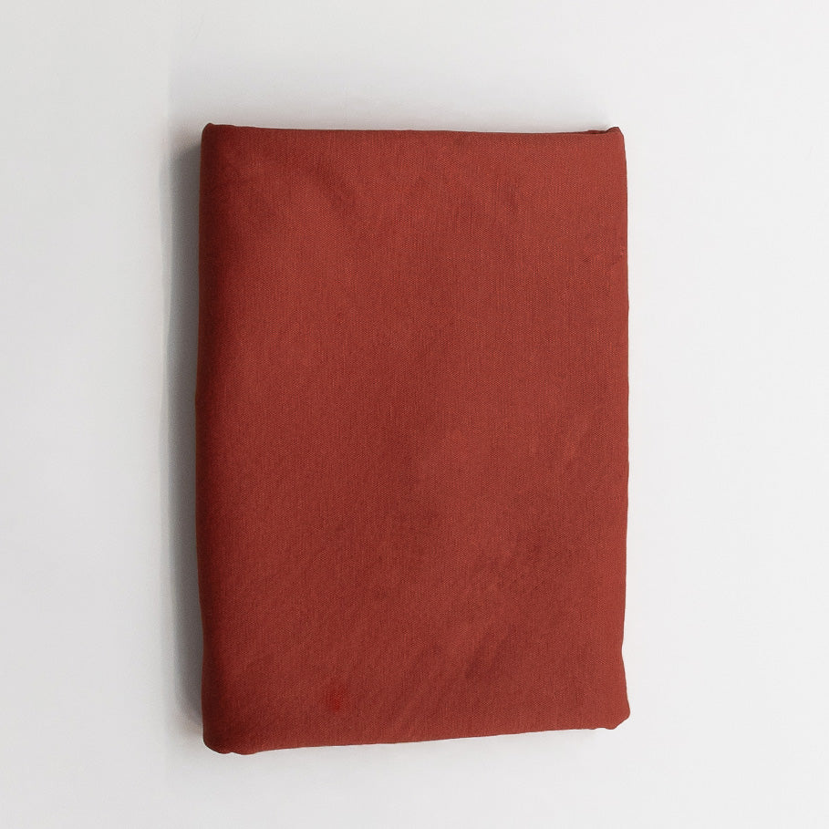 Folded red fabric on a white background