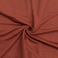 Close-up of dark redish brown fabric with a swirl pattern