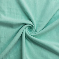 Close-up of mint fabric with a swirl pattern