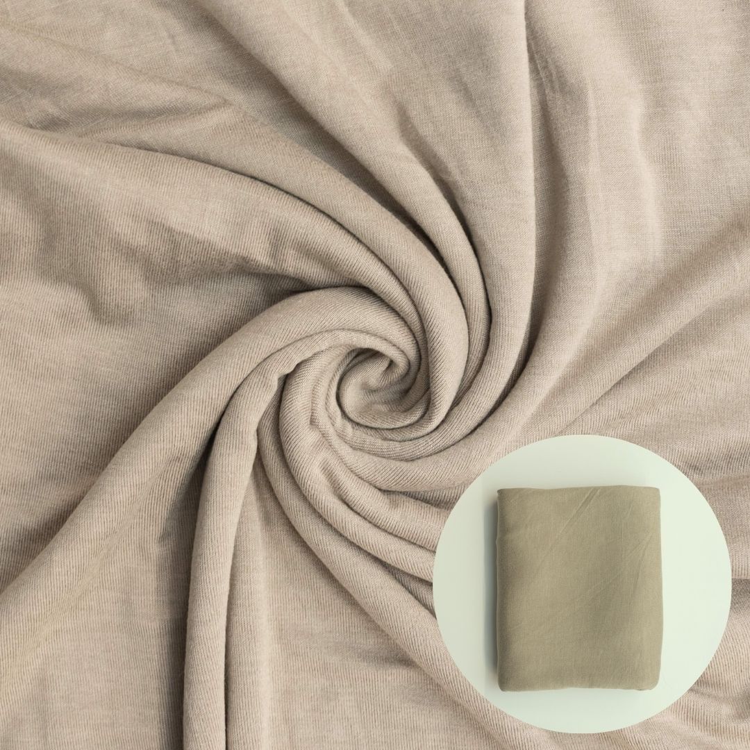 Close-up of beige fabric with a swirled pattern and inset showing a square swatch.