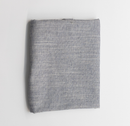 Folded fabric with a bankers stripe pattern on a light gray background