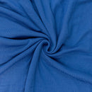 Close-up of blue sweater fabric in a swirl pattern
