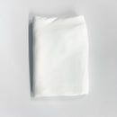 White folded fabric a light gray background