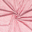 Pink fabric with a swirling pattern