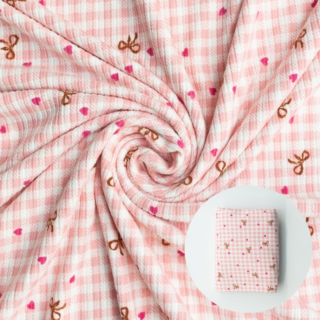Pink checkered fabric with decorative elements on a white background