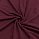 Close-up of dark red fabric with a swirl pattern