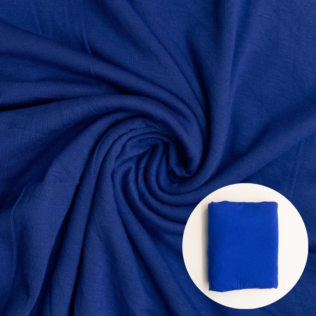 Close-up of blue fabric with a smaller inset showing a folded blue square.