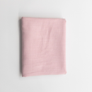 Folded pink fabric on a light gray background