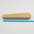 Wooden object with a measuring tape for scale on a light gray background