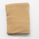 Folded beige fabric on a white background