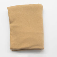 Folded beige fabric on a white background