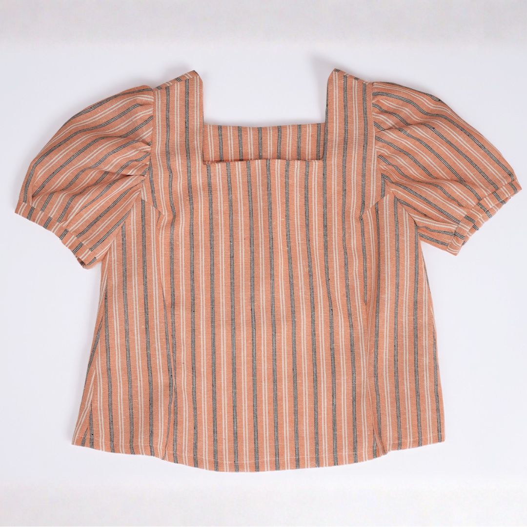 A bright orange sleeveless top featuring a square neckline and vertical line texture, laid flat on a clean white background.