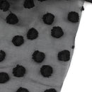 Sheer black fabric with raised black jacquard dots, shown on white