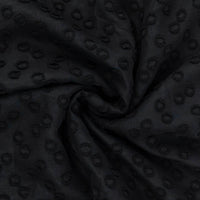 Black jacquard dot fabric in a swirl