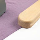Wooden tailor's clapper pressing lavender fabric