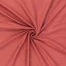 Peachy coral jersey rib knit fabric in a swirl