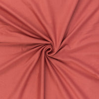 Peachy coral jersey rib knit fabric in a swirl