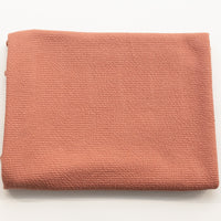 Pink rose textured knit fabric, folded