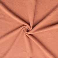 Pink rose textured knit fabric in a swirl
