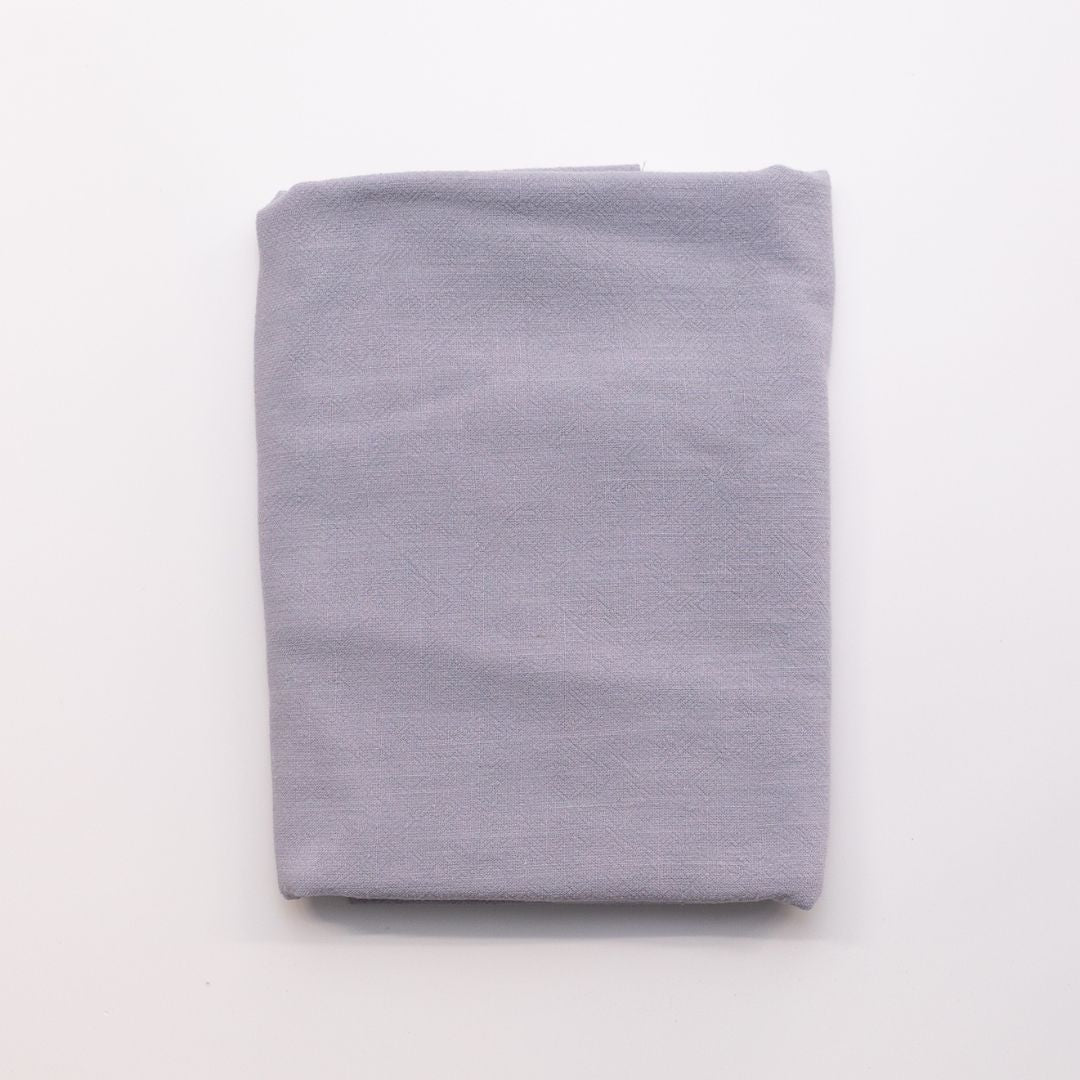 Folded light gray fabric on a white background