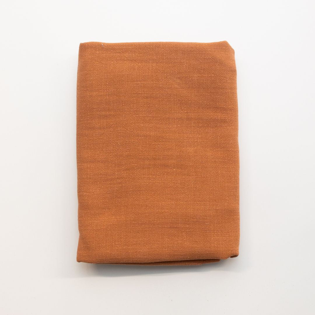 Folded orange fabric on a white background