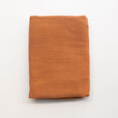 Folded orange fabric on a white background