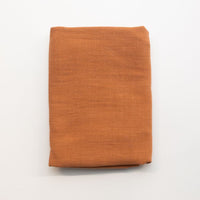 Folded orange fabric on a white background