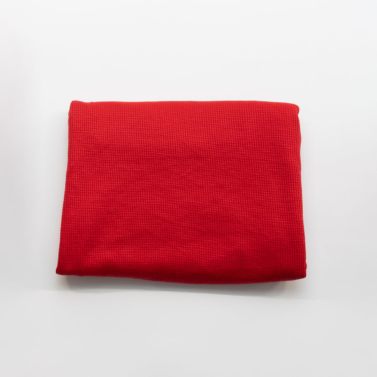 Tomato red thermal waffle knit fabric, folded